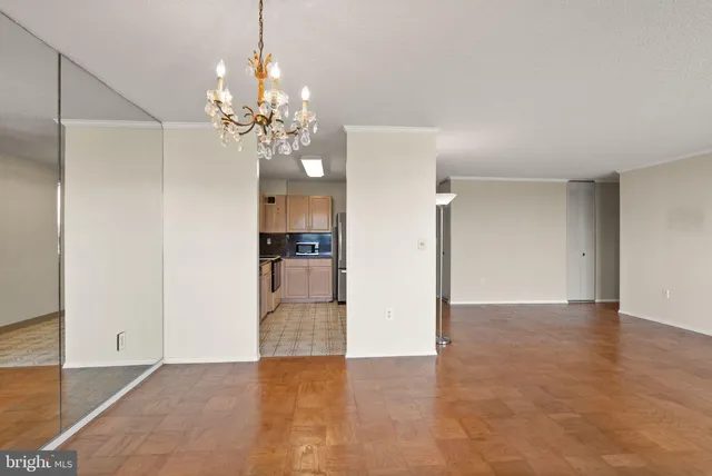 a view of a kitchen with a refrigerator and a chandelier