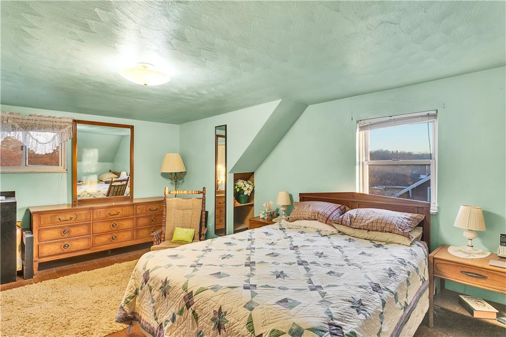 600 Colfax Street Springdale, PA 15144 - Photo 13 of 18 a bedroom with a large bed and a dresser