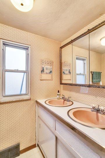 600 Colfax Street Springdale, PA 15144 - Photo 14 of 18 a bathroom with a sink and a mirror