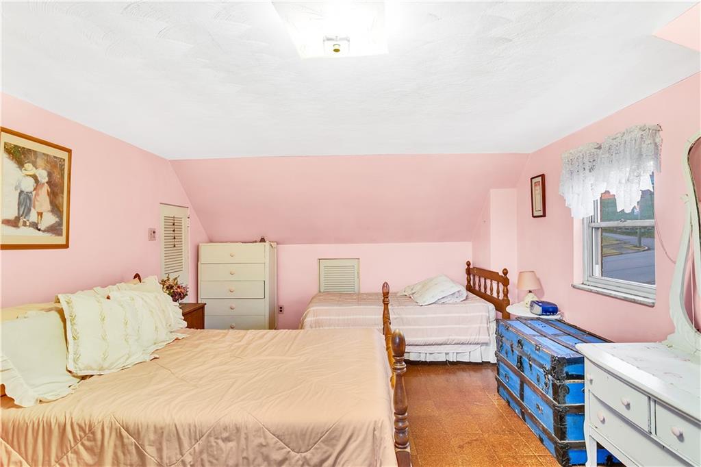 600 Colfax Street Springdale, PA 15144 - Photo 15 of 18 a bedroom with a bed and wooden floor