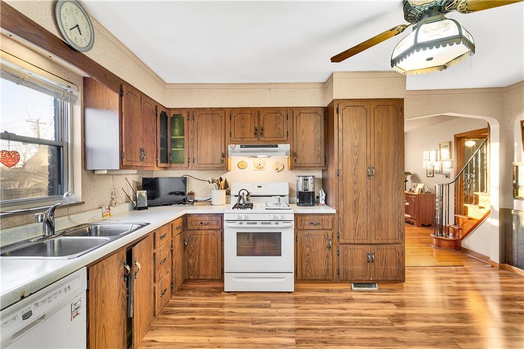 600 Colfax Street Springdale, PA 15144 - Photo 7 of 18 a kitchen with a stove a sink and a refrigerator