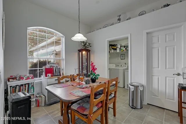 a view of a dining room with furniture and a chandelier