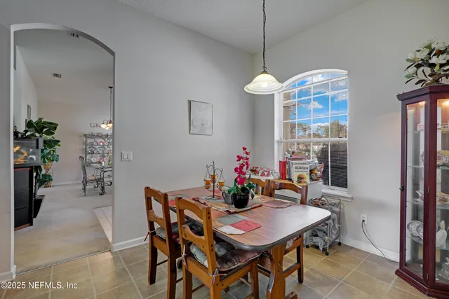 a dining room with furniture and chandelier