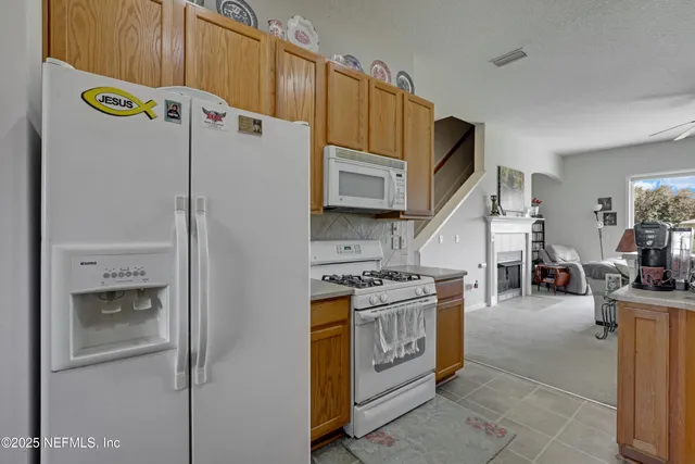 a kitchen with stainless steel appliances granite countertop a refrigerator and a stove