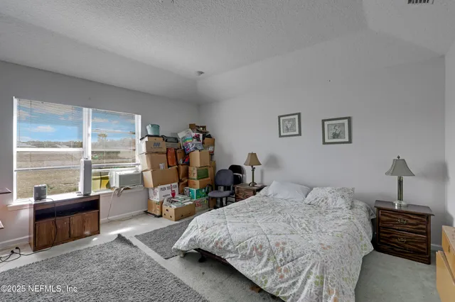 a bedroom with bed and wooden floor