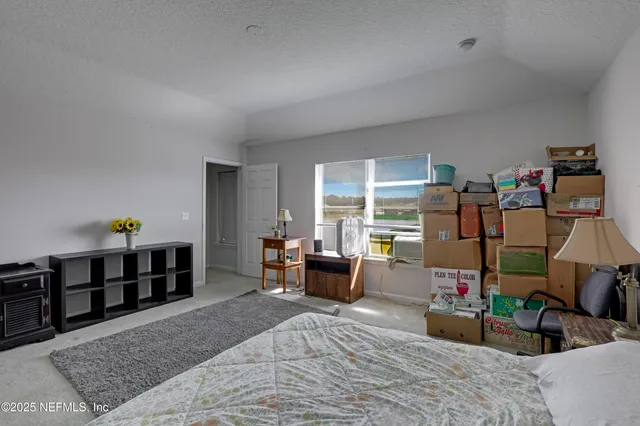 a bedroom with furniture and a wooden floor
