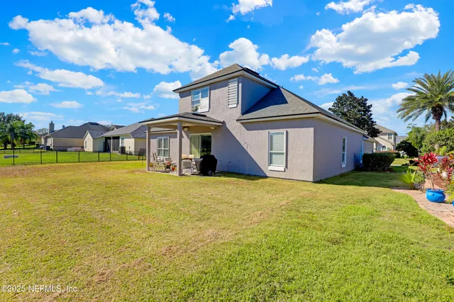 a front view of house with yard and swimming pool