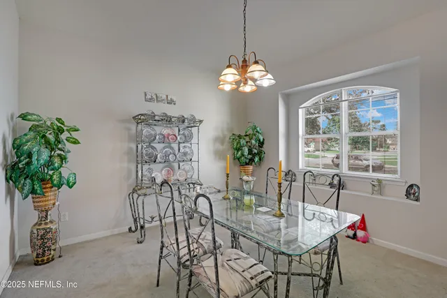 a view of a dining room with furniture window and chandelier