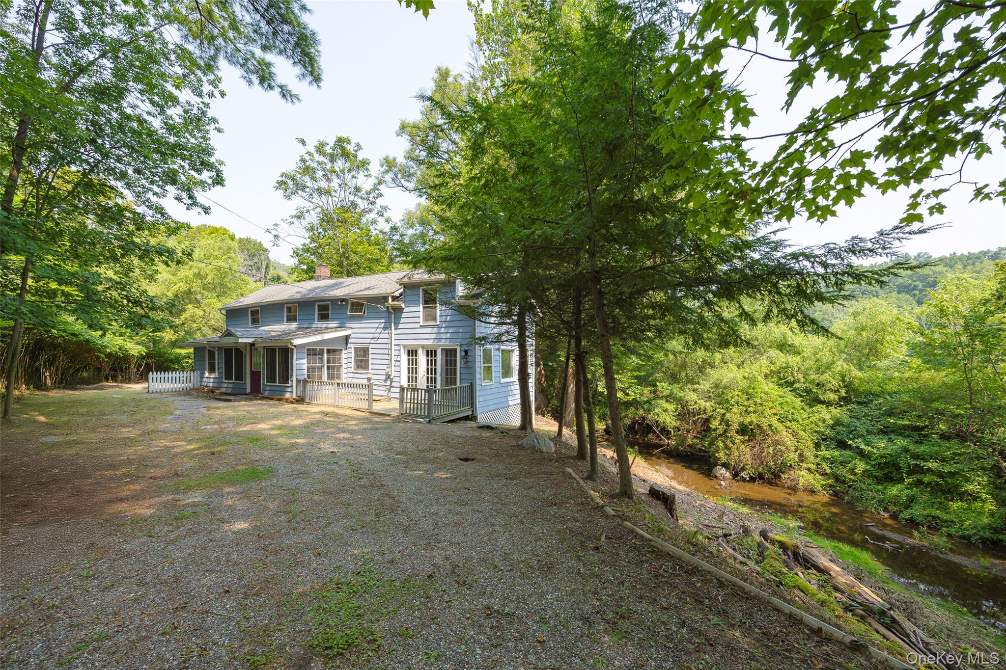 14 Old Rte 55 Pawling, NY 12564 - Photo 3 of 27 Back of house featuring a sunroom, a chimney, and a wooded view