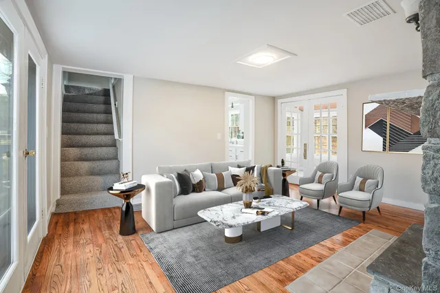 a living room with furniture wooden floor and a rug