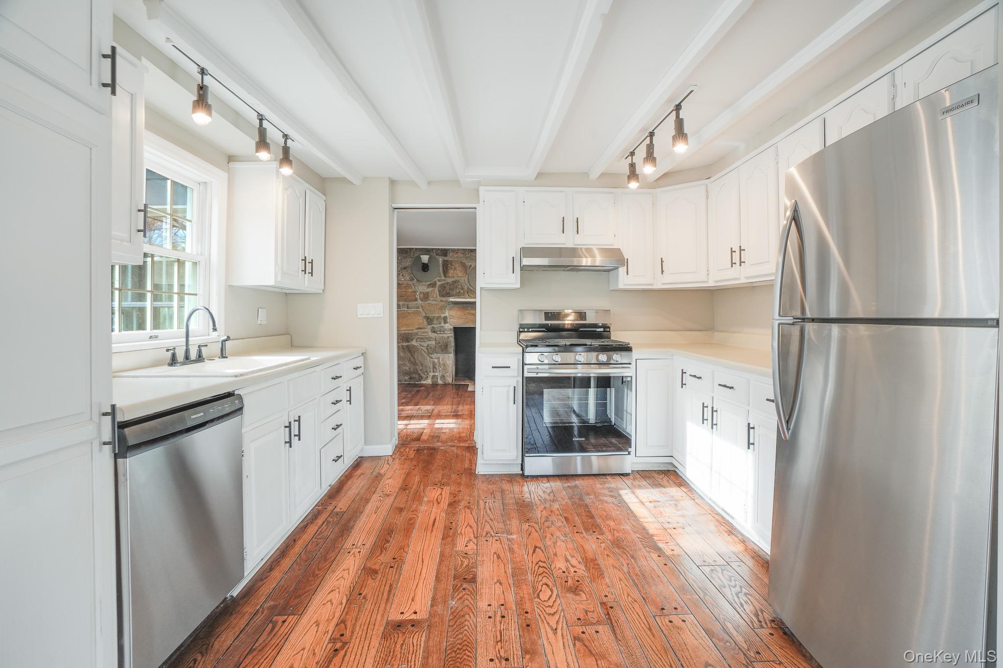 14 Old Rte 55 Pawling, NY 12564 - Photo 7 of 27 Kitchen featuring track lighting, appliances with stainless steel finishes, light countertops, beam ceiling, and white cabinets