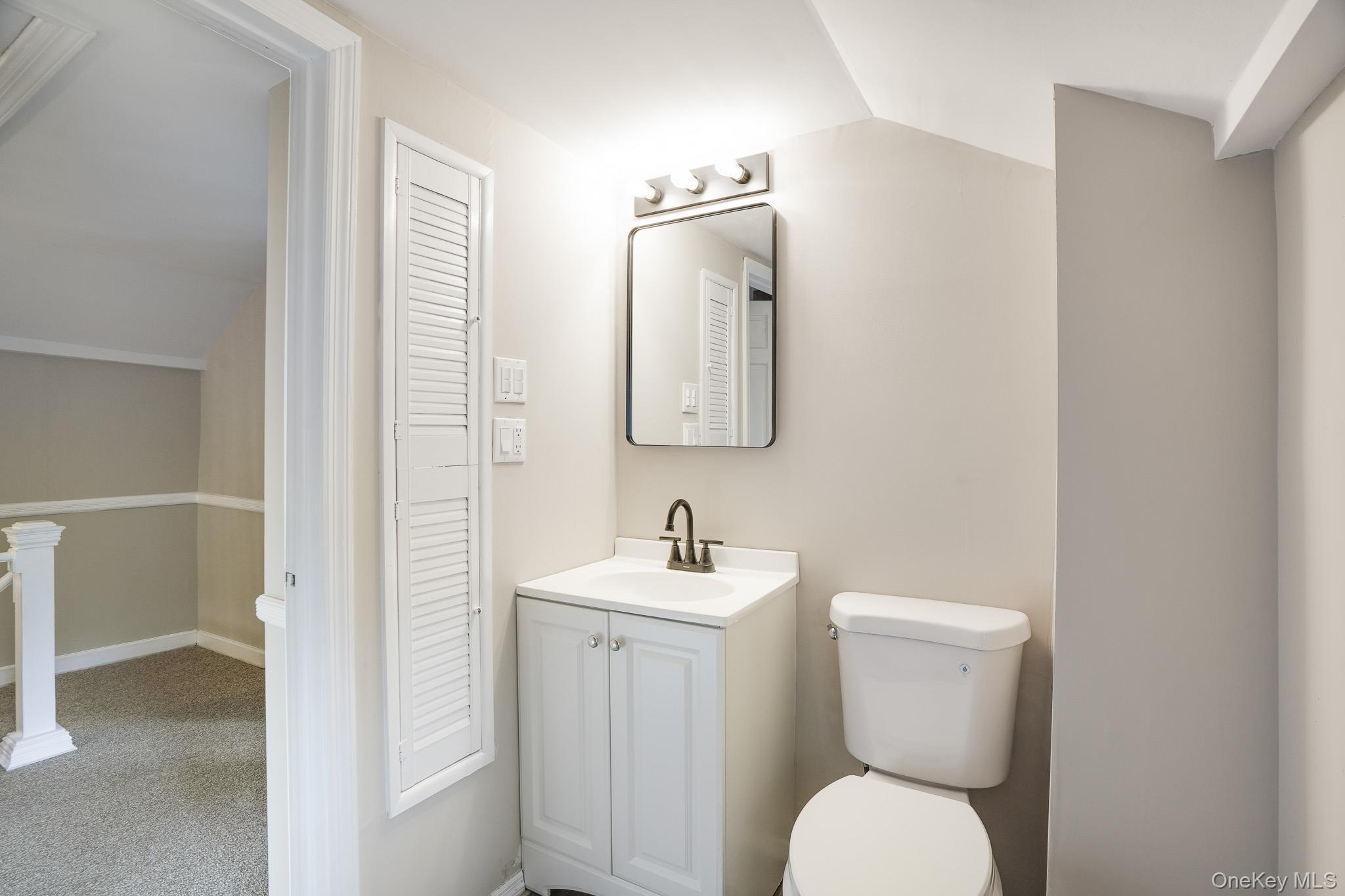 14 Old Rte 55 Pawling, NY 12564 - Photo 10 of 27 Half bath featuring vanity, light carpet, and lofted ceiling
