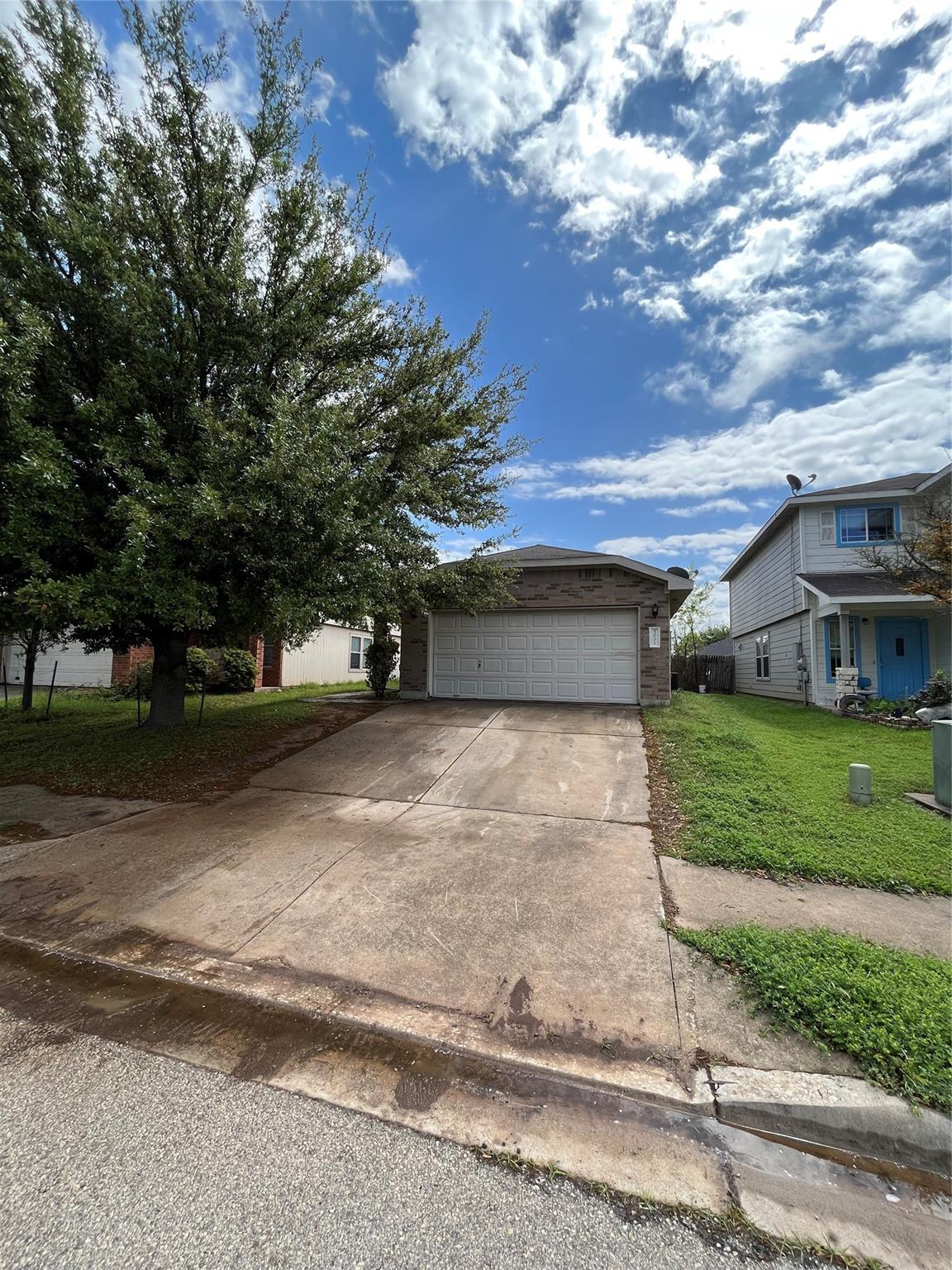 3001 Caleb Drive Austin, TX 78725 - Photo 1 of 16 View of front of home with a front lawn, driveway, and brick siding