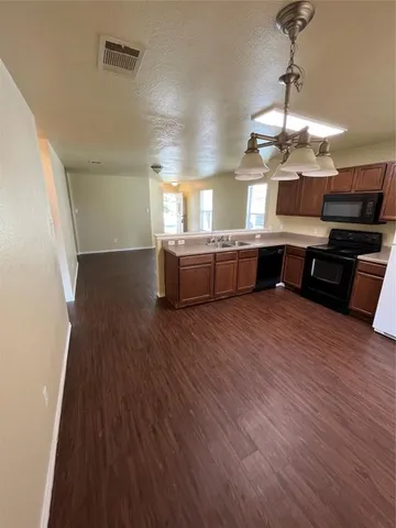 a large kitchen with a wooden floor