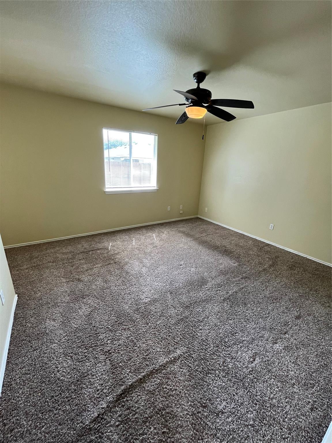 3001 Caleb Drive Austin, TX 78725 - Photo 6 of 16 Carpeted spare room featuring a textured ceiling and baseboards