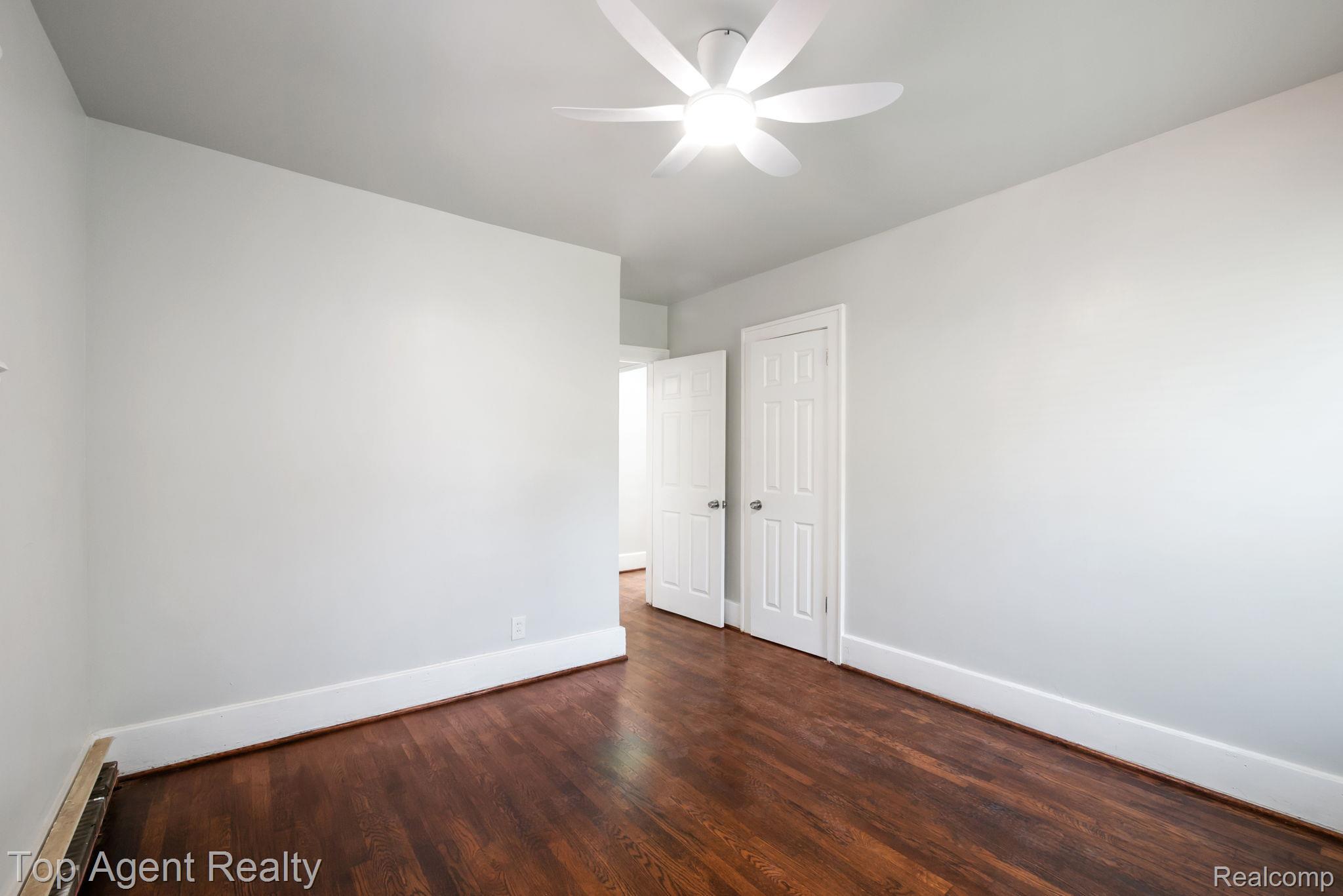 19217 Reno Street Detroit, MI 48205 - Photo 20 of 45 Hardwood flooring, painted walls, ceiling-mounted light fixture, and white doors