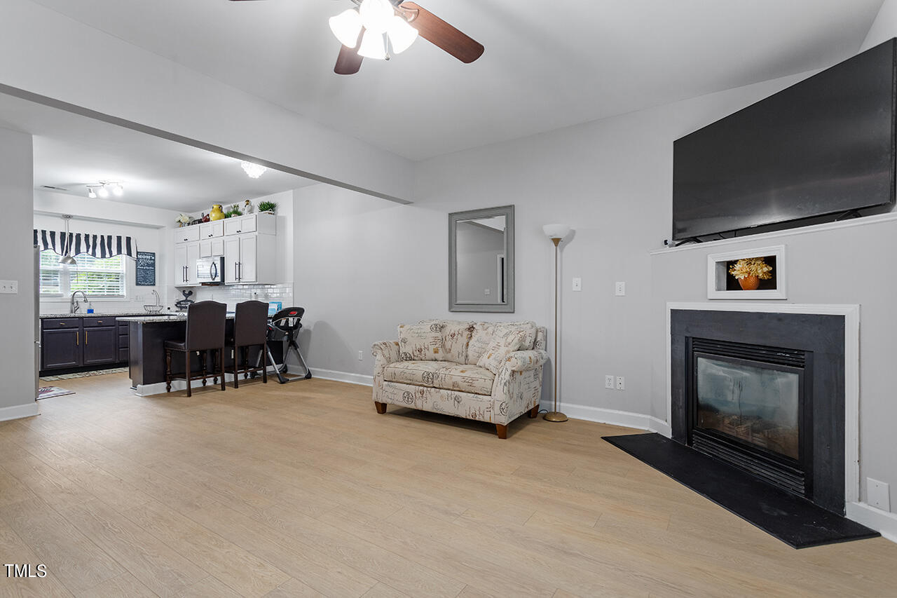 4642 Centrebrook Circle Raleigh, NC 27616 - Photo 11 of 27 In addition to high ceilings and a ceiling fan, this room also has a functional gas fireplace - the perfect addition to huddle around the hearth in colder weather.