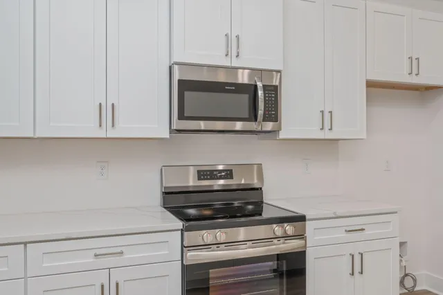 a kitchen with appliances a cabinets and the counter top