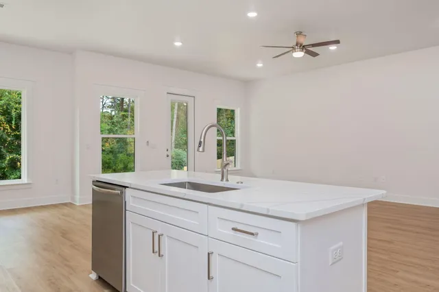a bathroom with a granite countertop sink a large mirror and a window