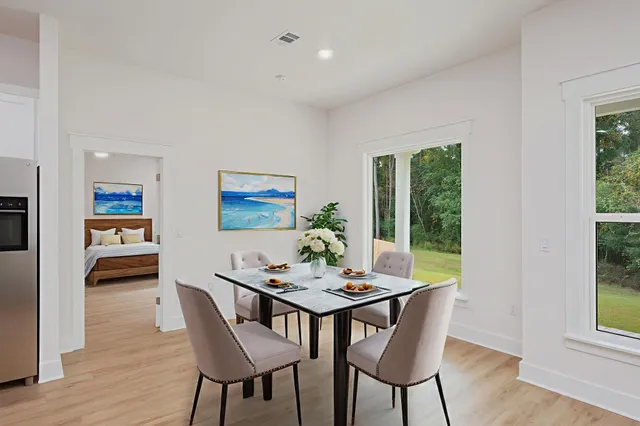 a view of a dining room with furniture window and wooden floor