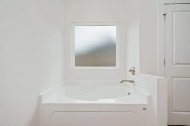 a white bath tub sitting next to a white sink