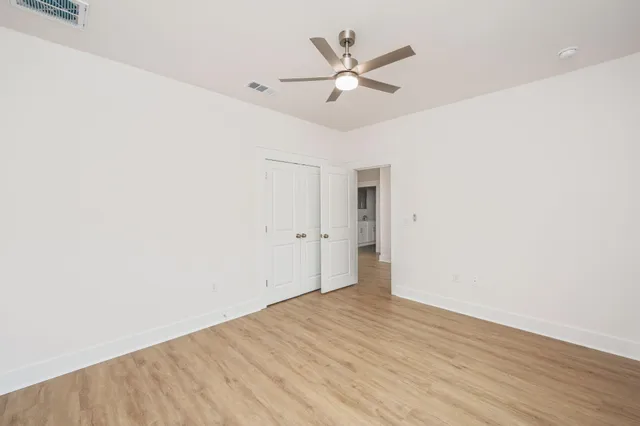 a view of a room with wooden floor