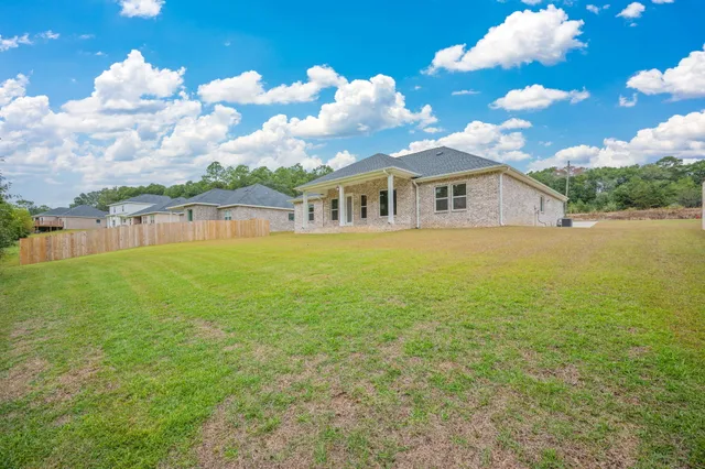 a view of a big yard with an outdoor space and seating area