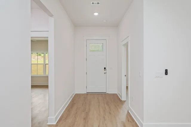 a view of a hallway with wooden floor