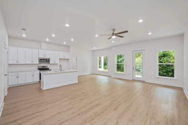 a view of kitchen with cabinets and wooden floor