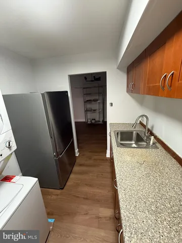 a kitchen with a refrigerator and a sink