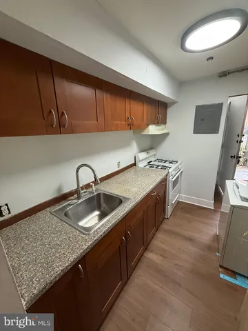 a kitchen with a sink stove and cabinets