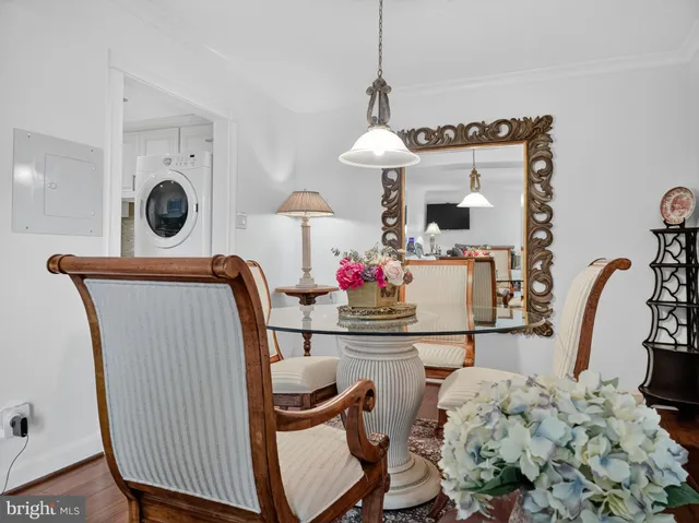 a view of dining room and kitchen with furniture and wooden floor