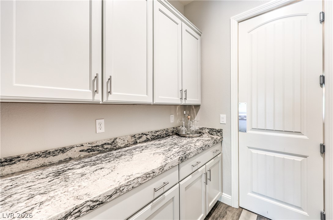 7119 Arabian Ridge Street Las Vegas, NV 89131 - Photo 19 of 73 An immaculate pantry with gleaming granite counters and abundant storage cabinetry awaits your culinary delights.