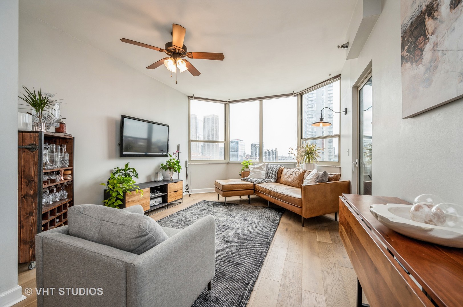 720 West Randolph Street, Unit 1002 Chicago, IL 60661 - Photo 2 of 10 a living room with furniture and a flat screen tv