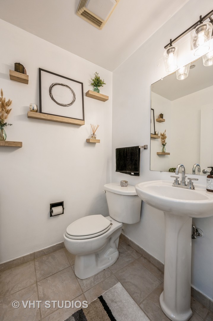 720 West Randolph Street, Unit 1002 Chicago, IL 60661 - Photo 8 of 10 a bathroom with a sink toilet and a mirror