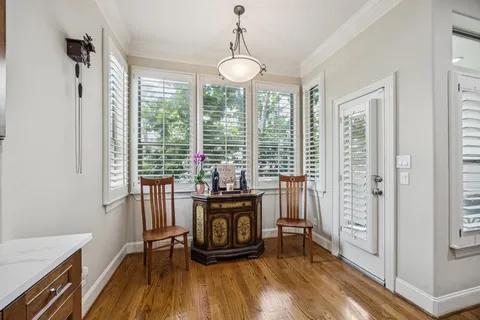 a view of a dining room with furniture and wooden floor