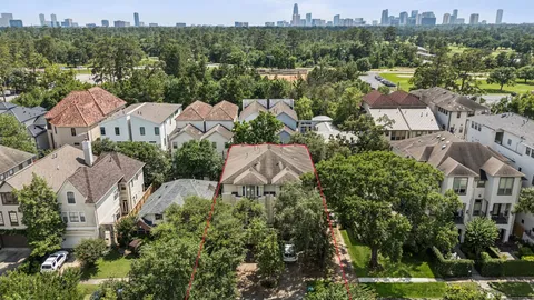 a picture of a bathroom with a white bed and a dresser