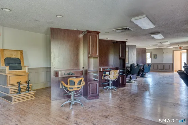 a living room with furniture a dining table and wooden floor