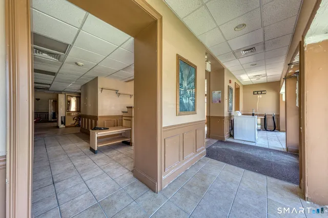 a view of a hallway with furniture and a livingroom