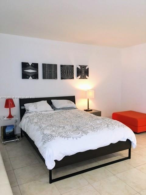 100 Lincoln Road, Unit 637 Miami Beach, FL 33139 - Photo 2 of 13 a bedroom with a bed and dresser