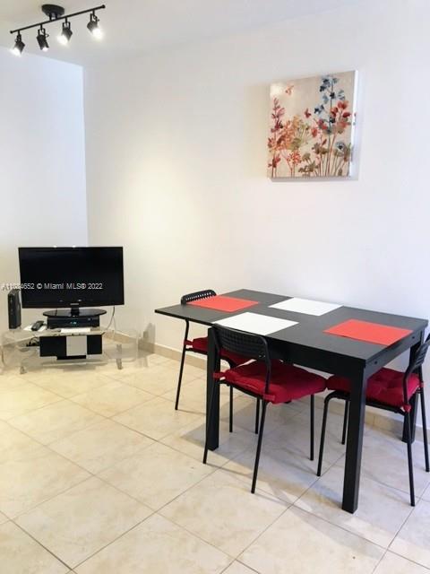 100 Lincoln Road, Unit 637 Miami Beach, FL 33139 - Photo 3 of 13 a workspace with furniture and a flat screen tv