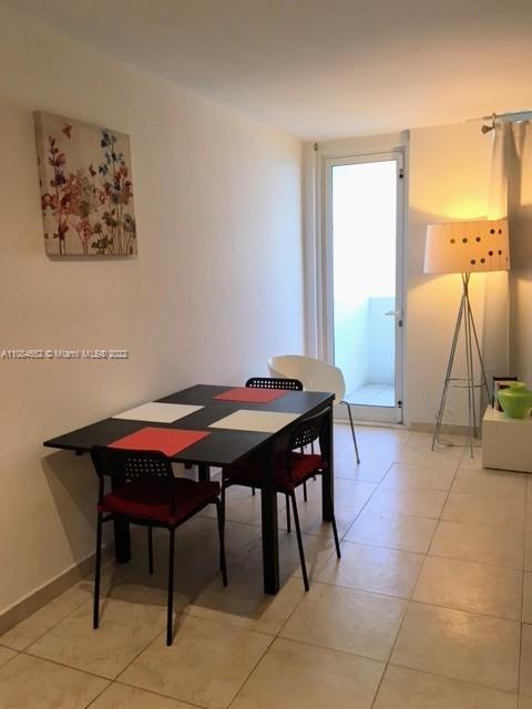 100 Lincoln Road, Unit 637 Miami Beach, FL 33139 - Photo 4 of 13 a dining room with a table and chairs