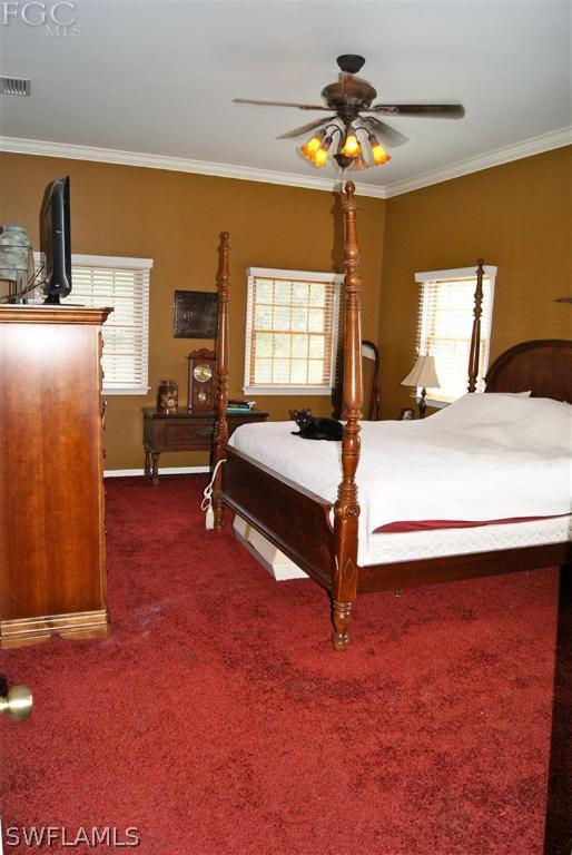 17180 Frank Road Alva, FL 33920 - Photo 10 of 23 a bedroom with a bed and a chandelier