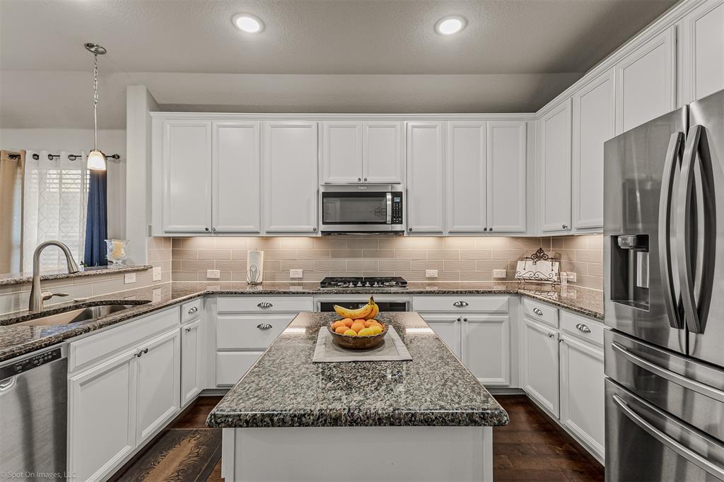 2064 Glaston Road Forney, TX 75126 - Photo 11 of 36 a kitchen with stainless steel appliances granite countertop a sink stove and refrigerator