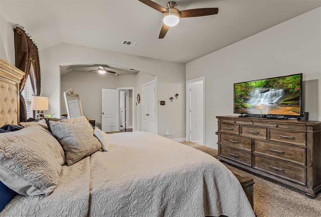 2064 Glaston Road Forney, TX 75126 - Photo 17 of 36 a bedroom with a bed and a flat screen tv