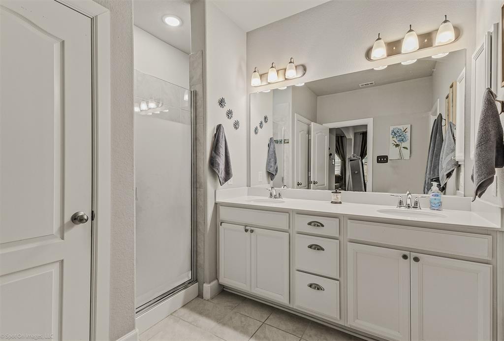 2064 Glaston Road Forney, TX 75126 - Photo 20 of 36 a bathroom with a double vanity sink and a mirror