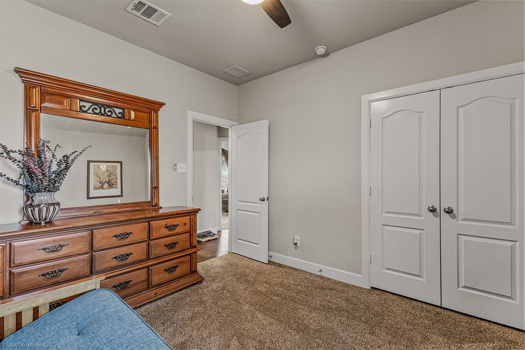 2064 Glaston Road Forney, TX 75126 - Photo 25 of 36 a spacious bedroom with a bed and a dresser
