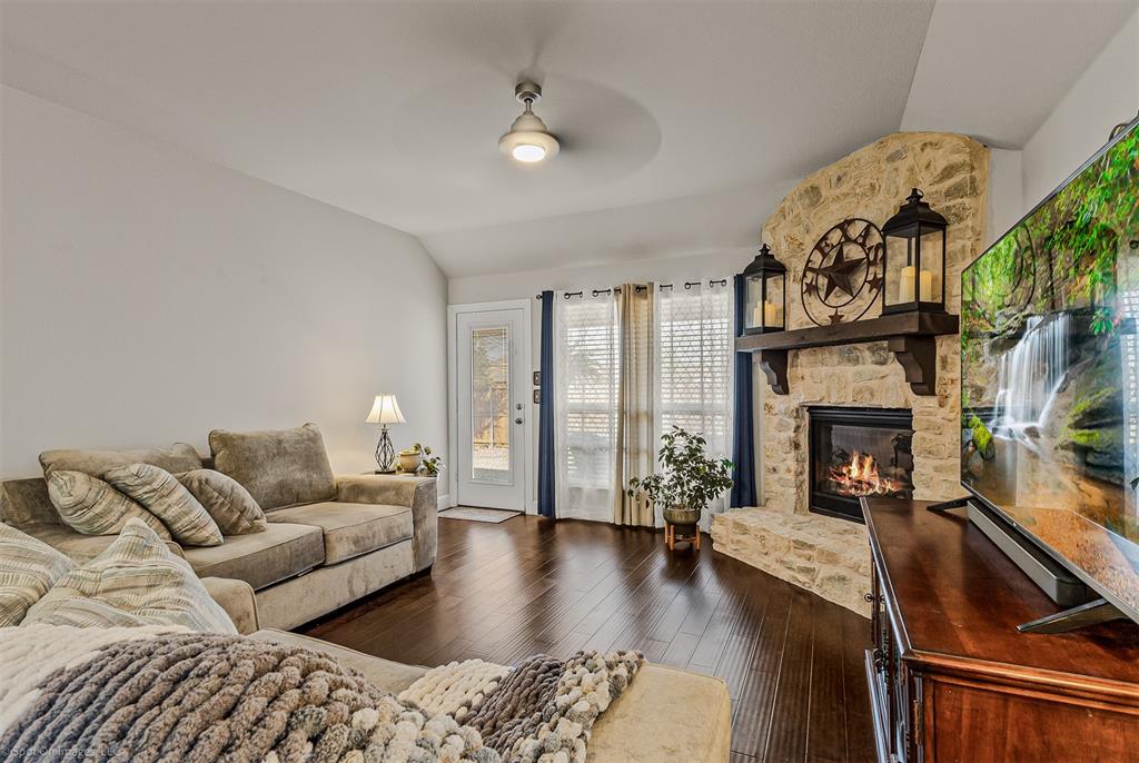 2064 Glaston Road Forney, TX 75126 - Photo 9 of 36 a living room with furniture a fireplace and a floor to ceiling window