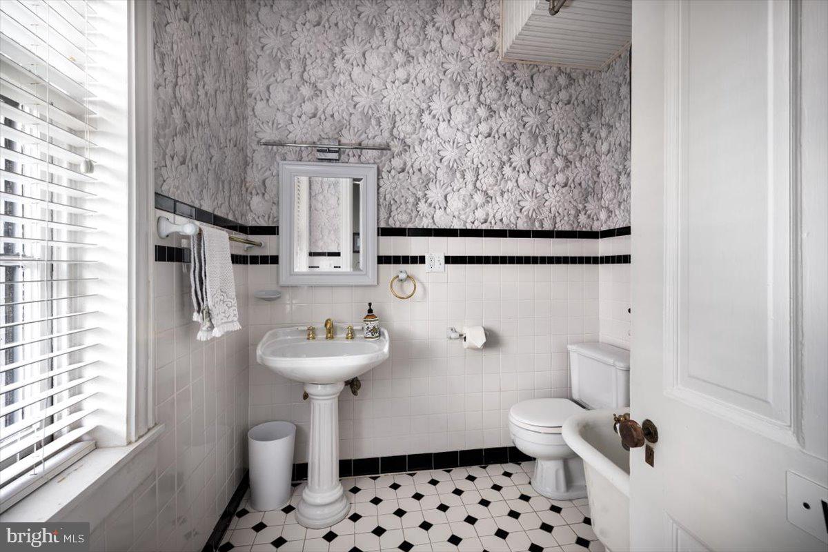 202 South Washington Street Winchester, VA 22601 - Photo 43 of 71 a bathroom with a sink toilet and a mirror