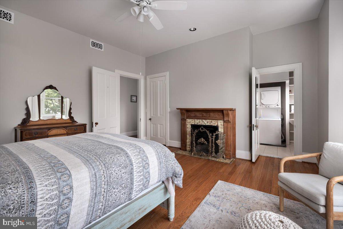 202 South Washington Street Winchester, VA 22601 - Photo 45 of 71 a spacious bedroom with a bed and a fireplace